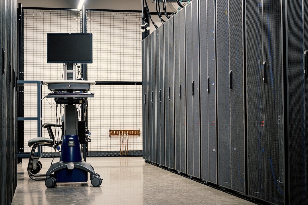 Rows of servers in a data center with a diagnostic cart