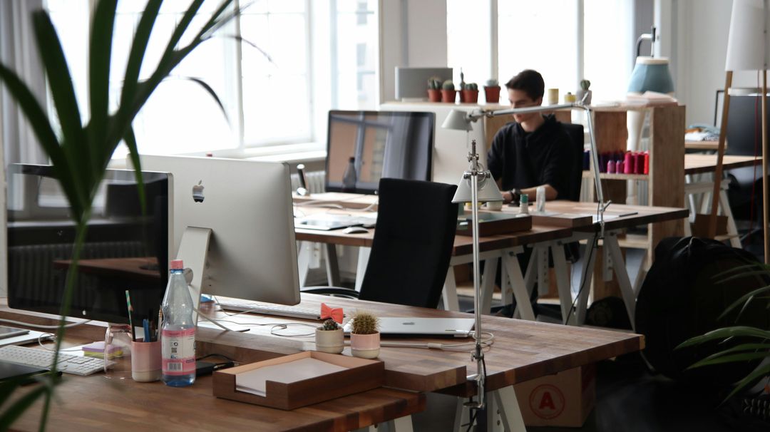 A focused professional working at a desk in a bright modern office